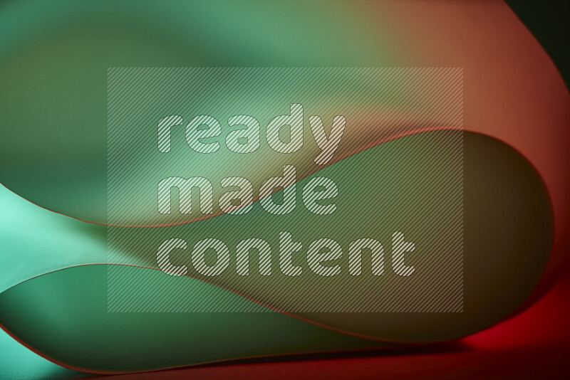 An abstract art piece displaying smooth curves in green and orange gradients created by colored light