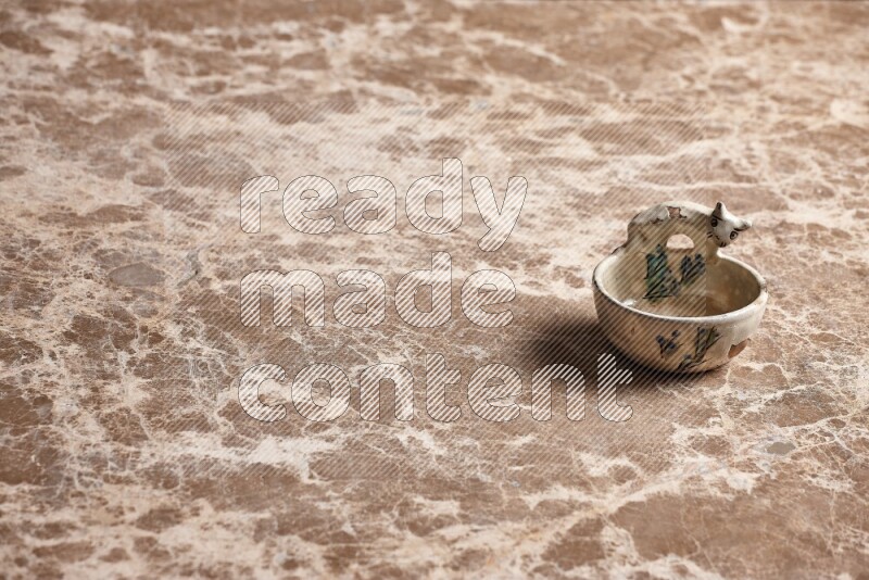 A pottery soap holder on beige marble background