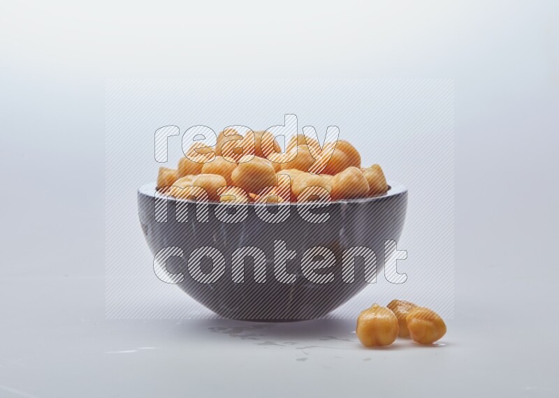 Close up shot of boiled chickpeas in a container on white background