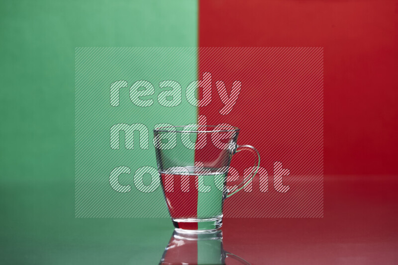 The image features a clear glassware filled with water, set against green and red background
