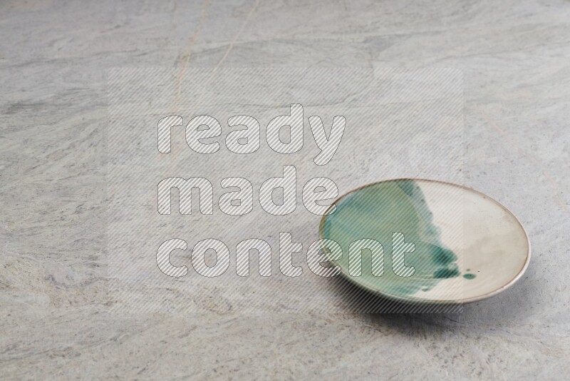 A multicolored pottery plate on grey marble background