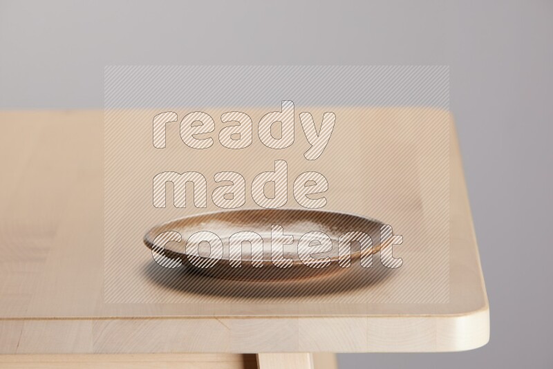 multi-colored pottery Plate on a wooden table edge