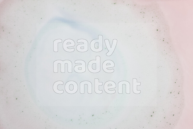 تظهر الصورة دوامة ناعمة من درجات الوردي الباستيل والأزرق الفاتح مع نقط خضراء علي خلفية بيضاء