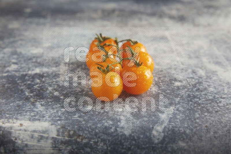 Orange cherry tomato vein on a textured rusty blue background 45 degree