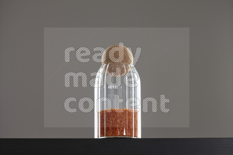 Lentils in a glass jar on black background
