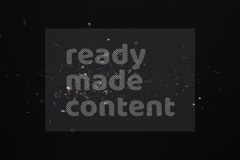 Falling multicolored confetti on black background