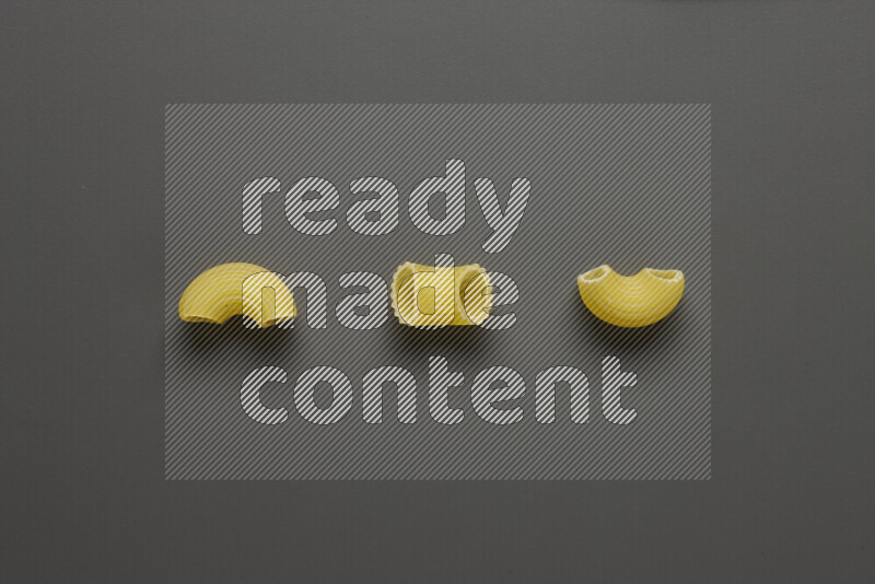 Elbow pasta on grey background