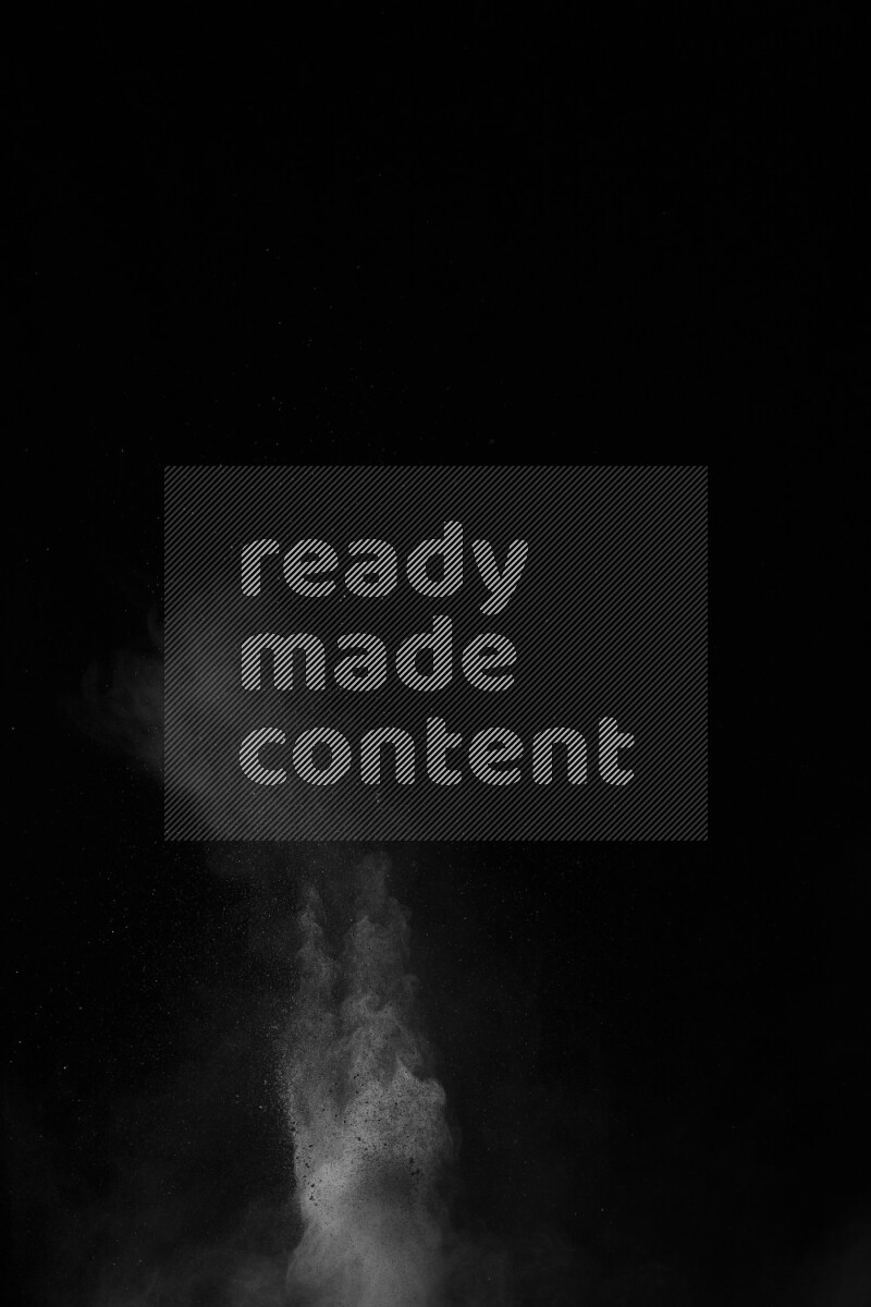 A side view of white powder explosion on black background