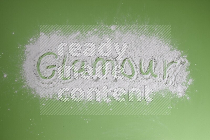 A word written with white powder on green background