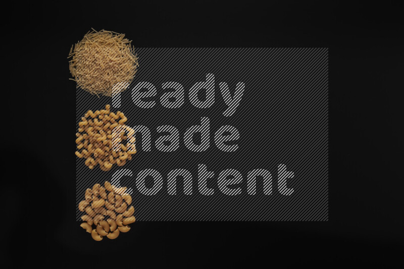 Different pasta types in 3 bunches on black background