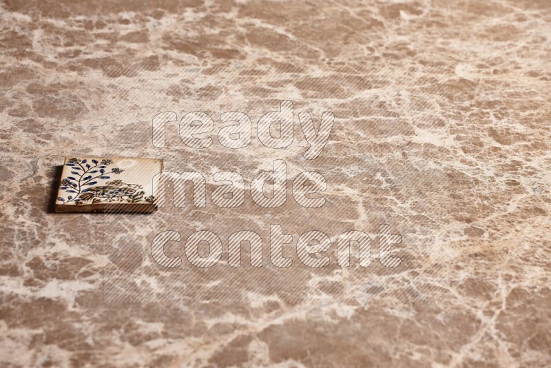 A decorative coaster on beige marble background