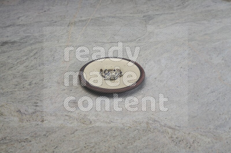 A decorative pottery plate on grey marble background