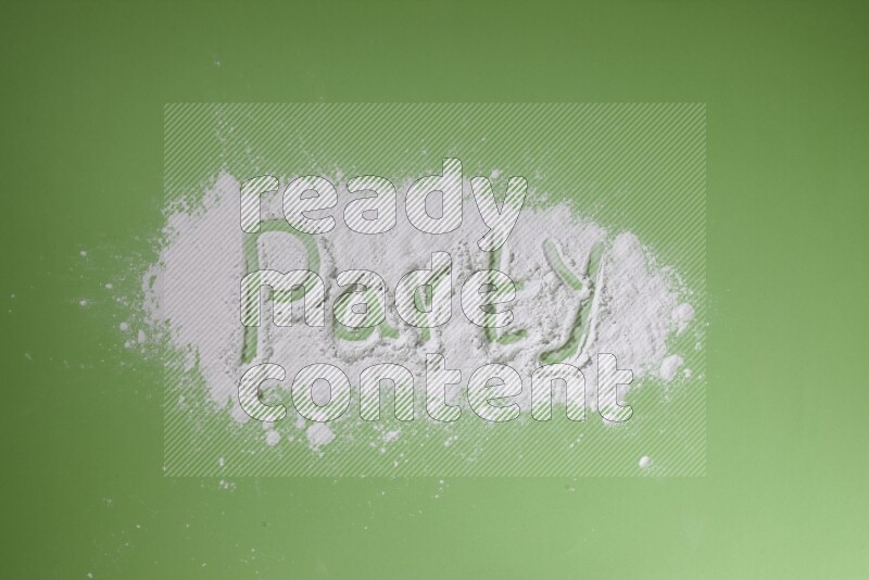 A word written with white powder on green background