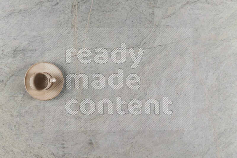 A multicolored pottery Cup on grey marble background