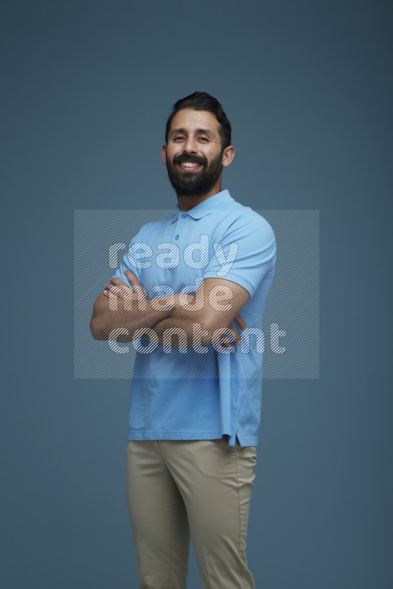 Man posing in a blue background wearing a Blue shirt