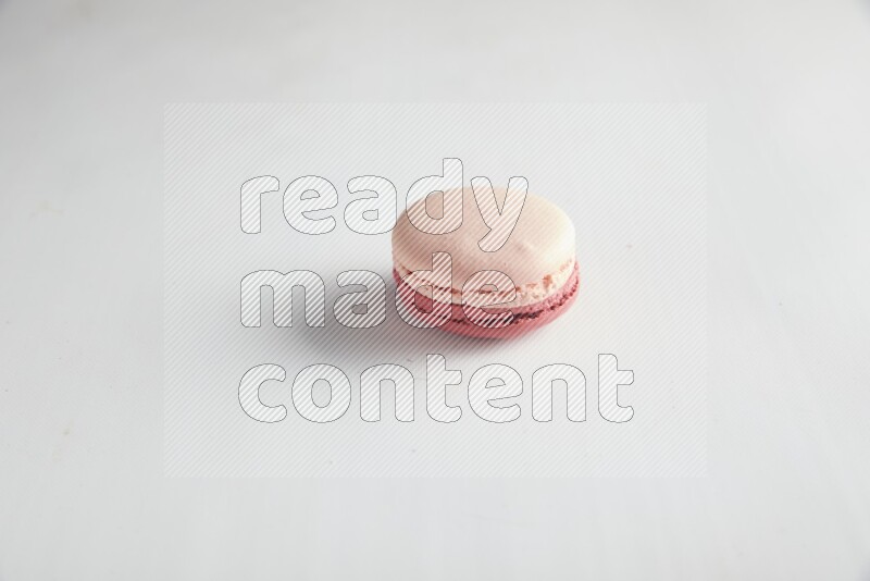 45º Shot of Pink Litchi Raspberry macaron on white background