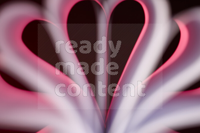An abstract art piece displaying smooth curves in pink gradients created by colored light