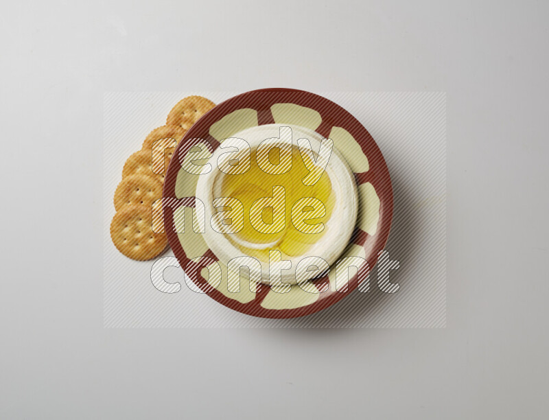 Lebnah garnished with olive oil in a traditional plate on a white background