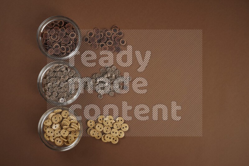 A brown collection of sewing and tailoring tools arranged on a brown background