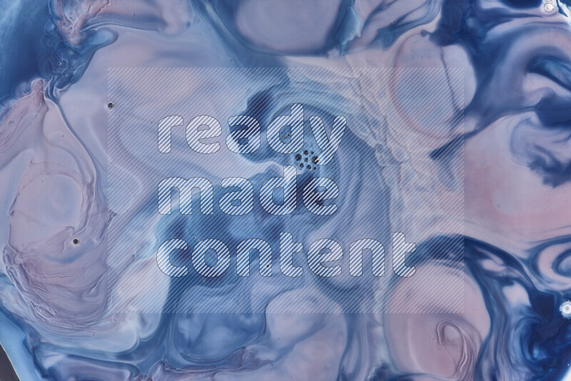 A close-up of abstract swirling patterns in blue, red and white