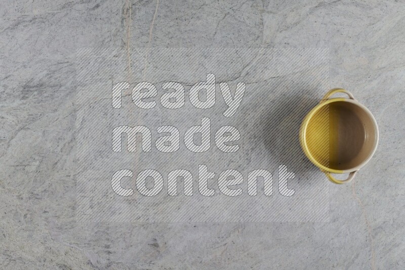 A multicolored pottery Bowl on grey marble background