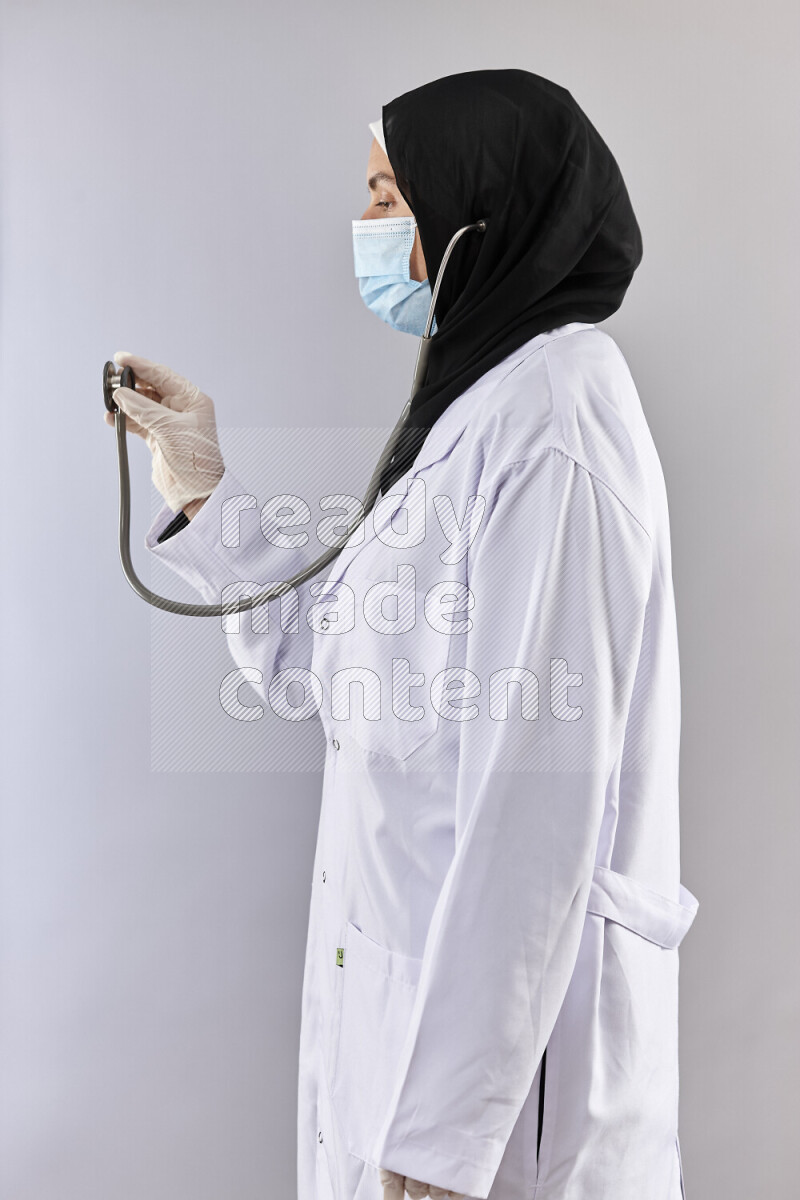 Female doctor wearing an abaya and medical attire in different positions