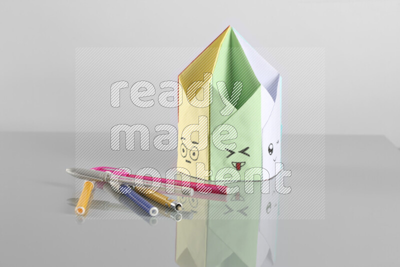 Origami pen holder on grey background