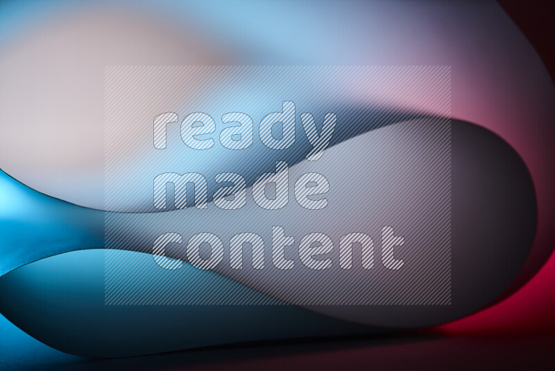 An abstract art piece displaying smooth curves in blue and red gradients created by colored light