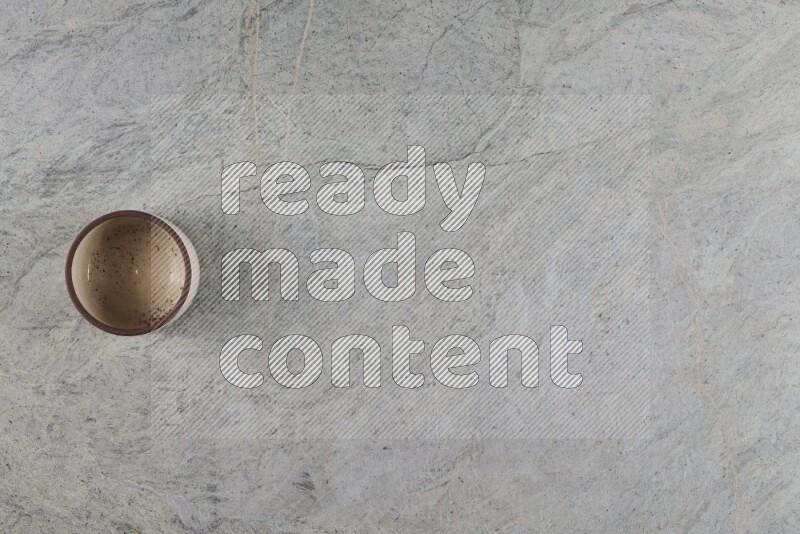 A multicolored pottery Bowl on grey marble background
