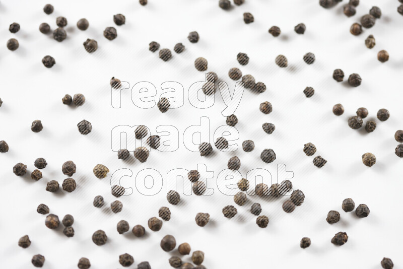 Black pepper beads on white background