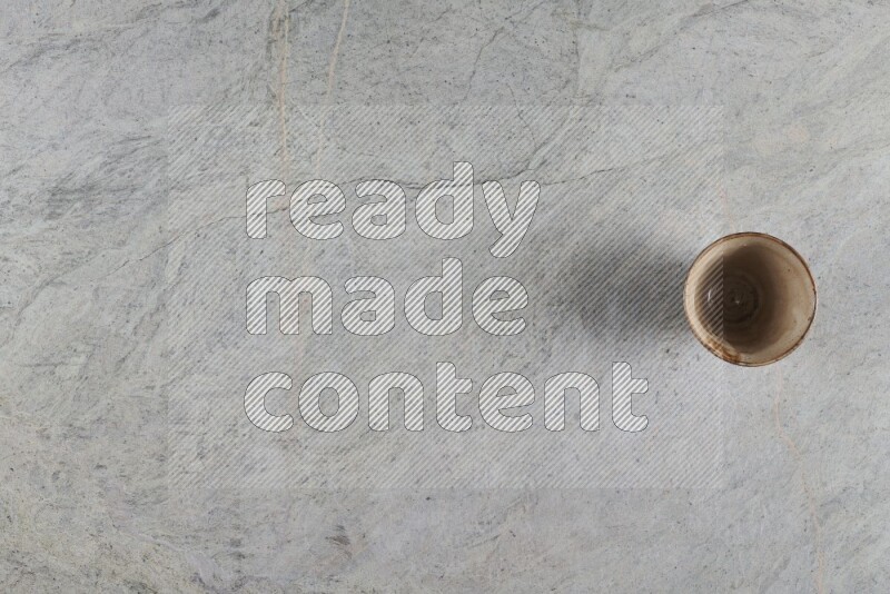 A multicolored pottery Cup on grey marble background