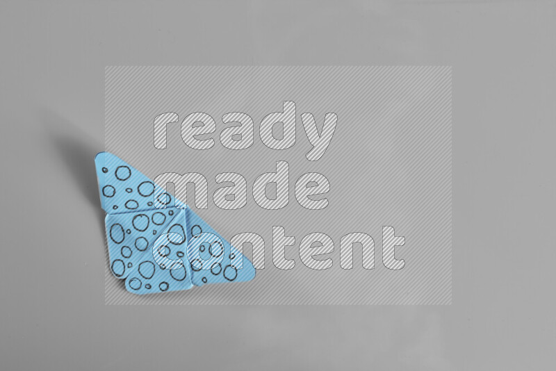 Origami butterfly on grey background