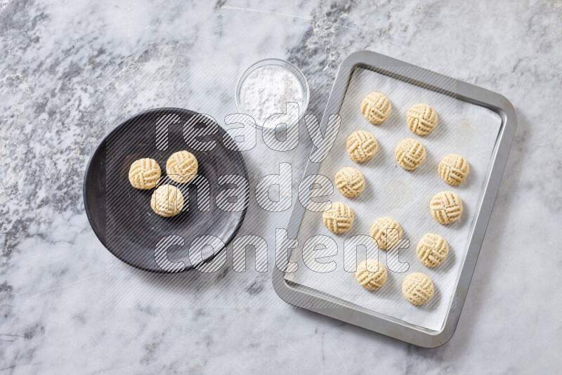 Kahk step by step with its ingredients ghee, sugar, flour, sesame, yeast, water and kahk flavor on grey marble background