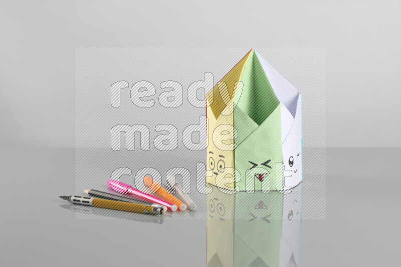 Origami pen holder on grey background