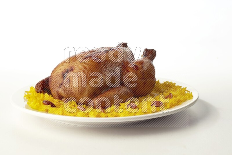 yellow  basmati Rice with  whole roasted chicken on a white rounded plate direct on white background