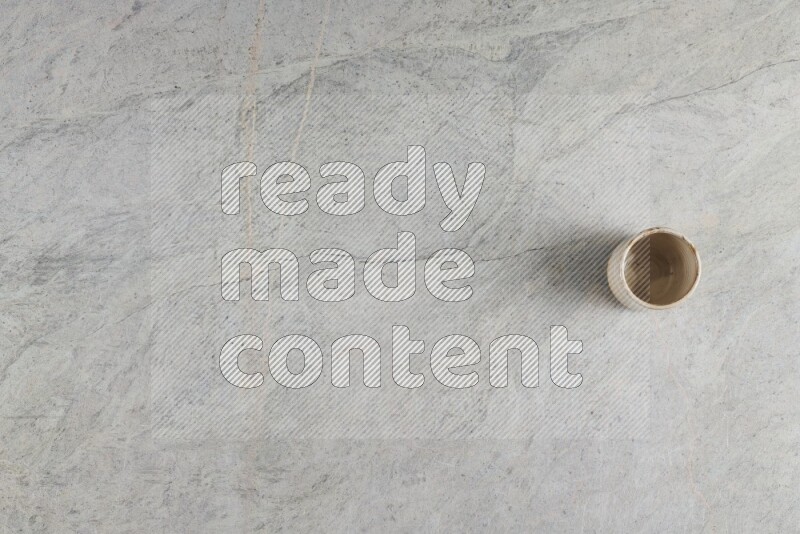 A multicolored pottery Cup on grey marble background