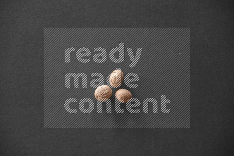 Nutmeg on a black flooring