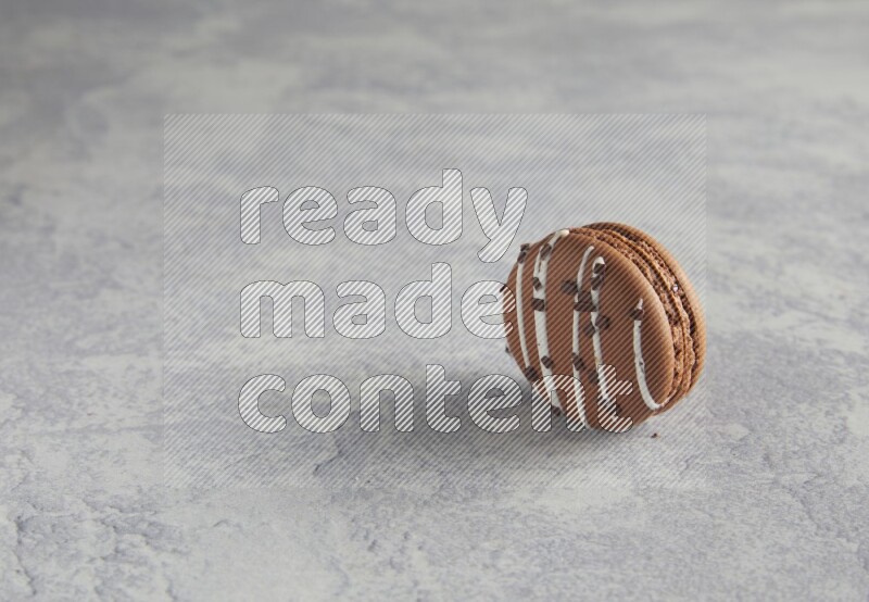 45º Shot of Brown white Chocolate Caramel macaron on white  marble background