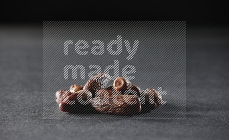 Dried dates on a black background in different angles