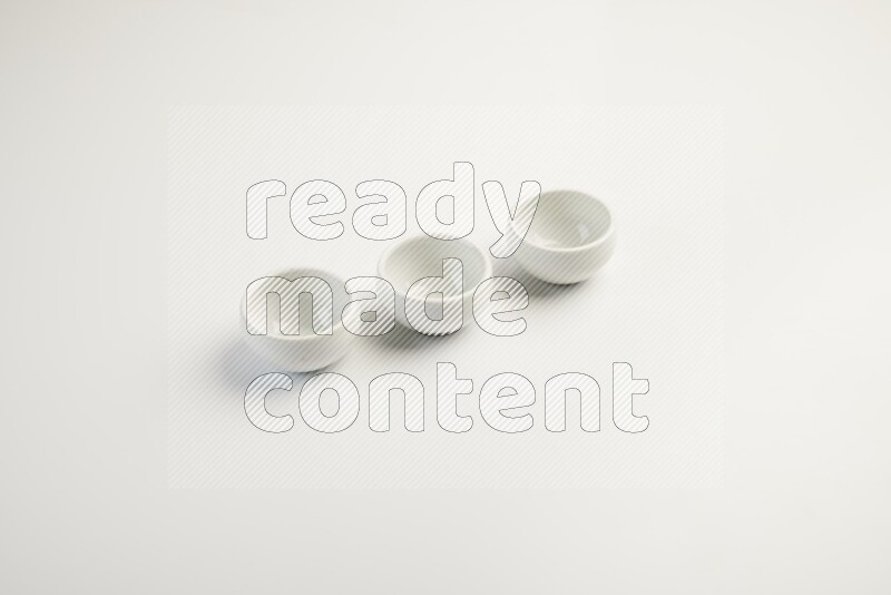white ceramic round sauce dish on white countertop