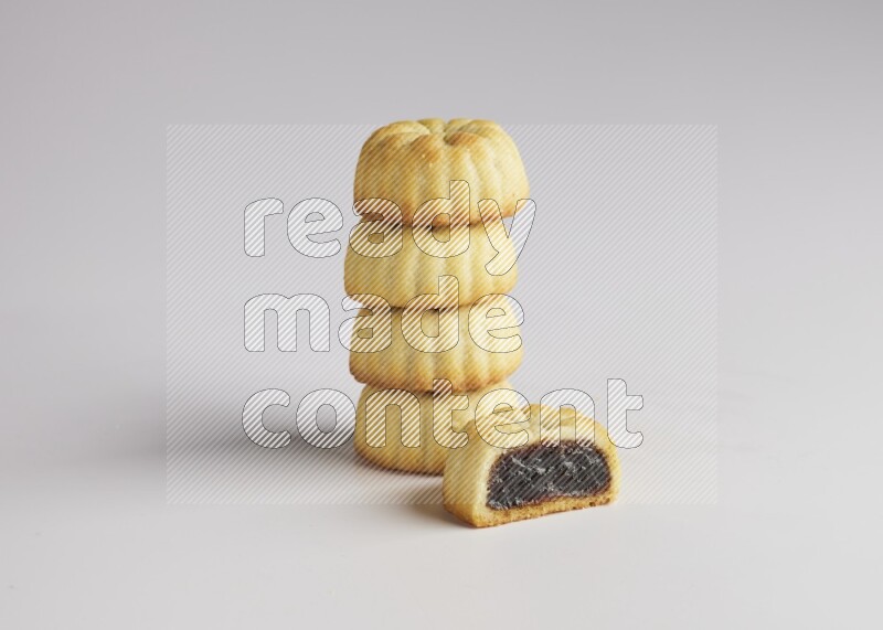 Five Pieces of Maamoul filled with date one of them is cut direct on white background
