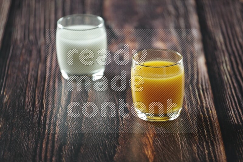 Cold drinks in a glass cup such as water, tamarind, qamar eldin, sobia, milk and hibiscus on wooden background