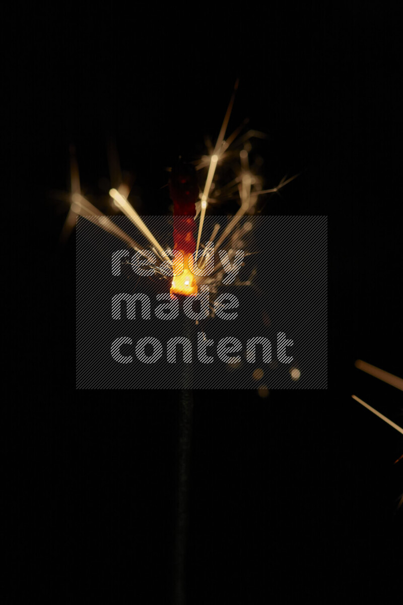 A close-up image of sparkler candle isolated on black background