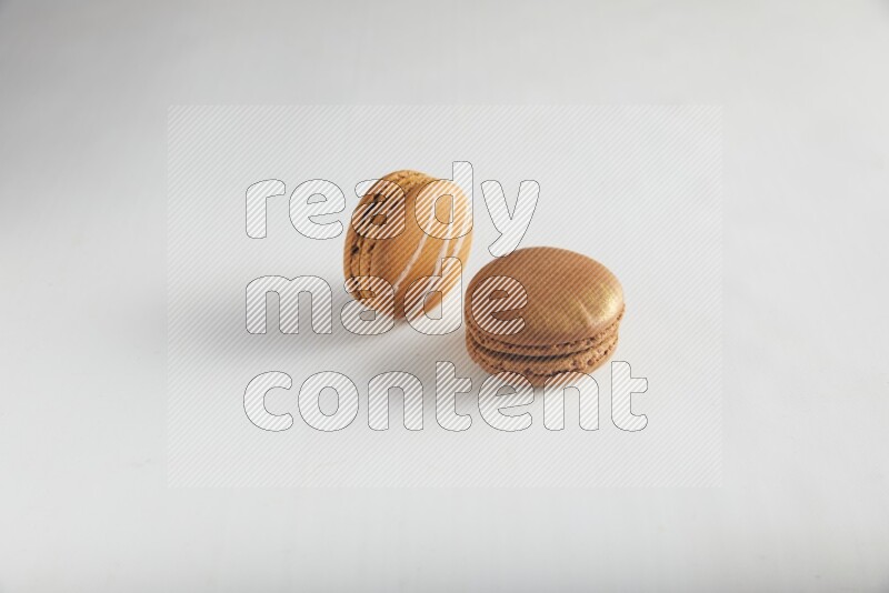 45º Shot of of two assorted Brown Irish Cream, and Brown Coffee macarons  on white background