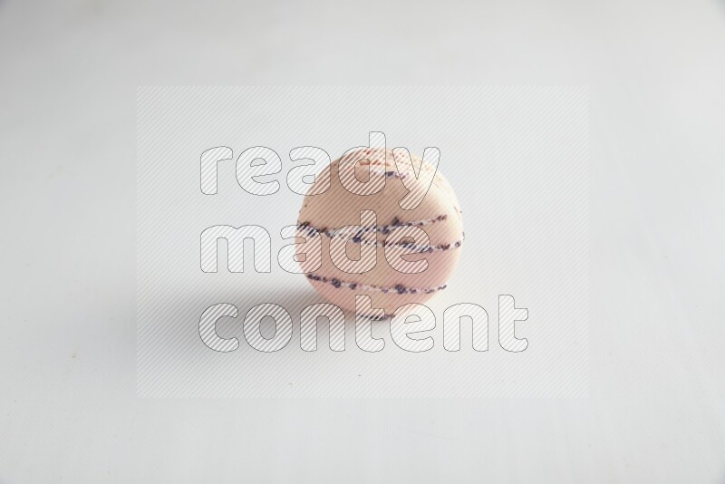 45º Shot of pink orange blossom macaron on white background