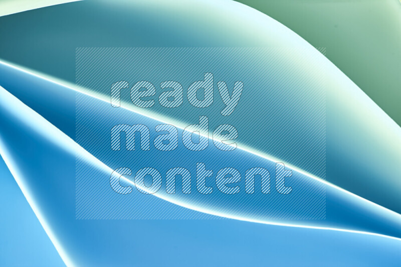 This image showcases an abstract paper art composition with paper curves in green and blue gradients created by colored light