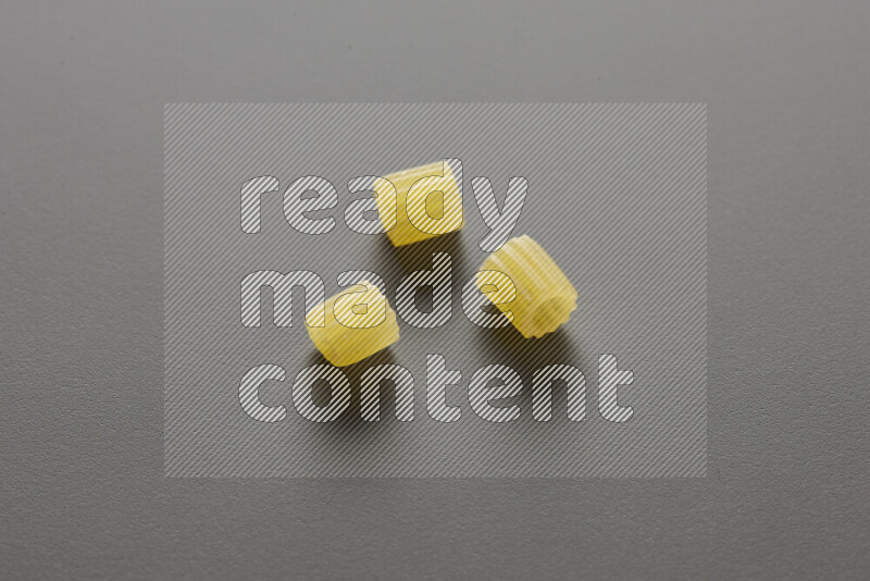Small rings pasta on grey background