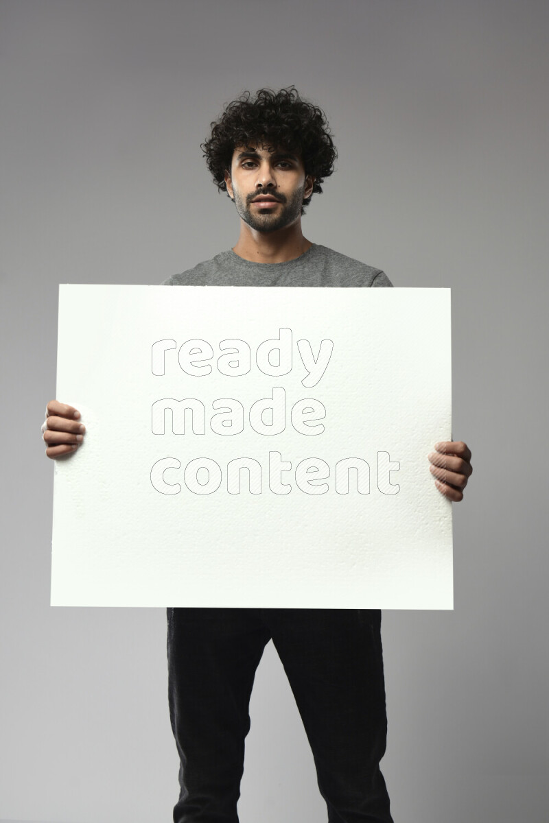 A man wearing casual standing and holding a white board on white background
