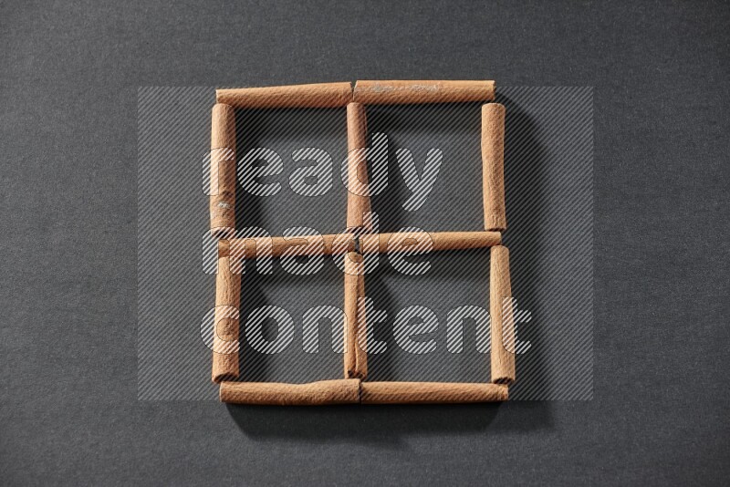 4 squares of cinnamon sticks on black flooring