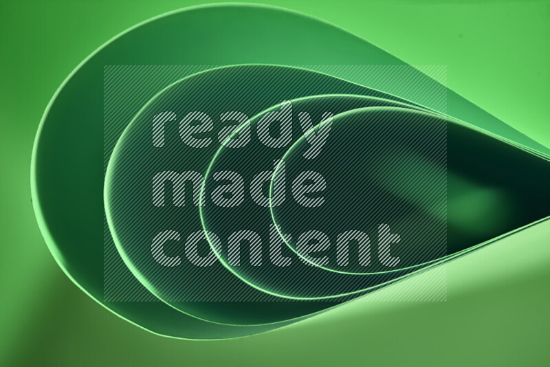 An abstract art of paper folded into smooth curves in green gradients
